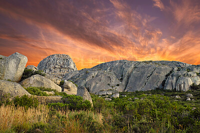 Buy stock photo Beautiful, bright and ambient sky at sunset with big boulders outdoors on a nature landscape. Dramatic scene of the wilderness at dawn in a natural, secluded and untouched wilderness environment