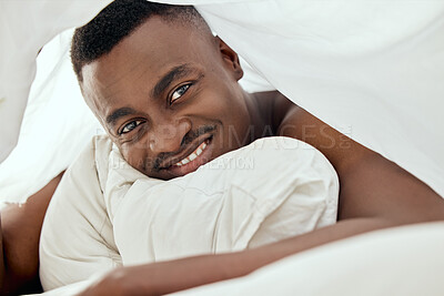 Buy stock photo Portrait, smile and black man in bedroom to relax for peace, calm and healthy morning energy in home apartment. Blanket, happy face and person in bed to wakeup, rest or comfort on pillow in Kenya