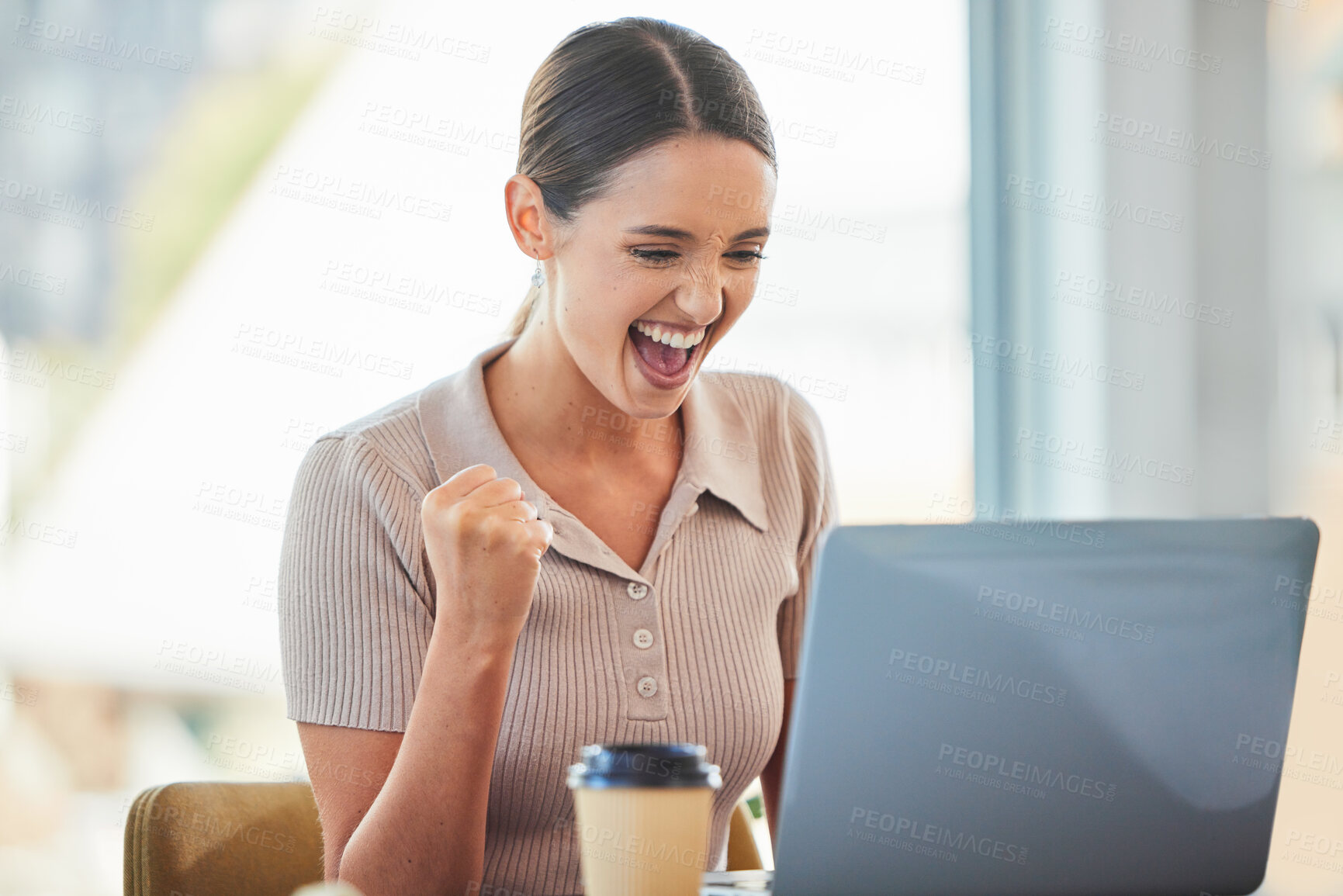 Buy stock photo Shot of a young businesswoman cheering while using her laptop