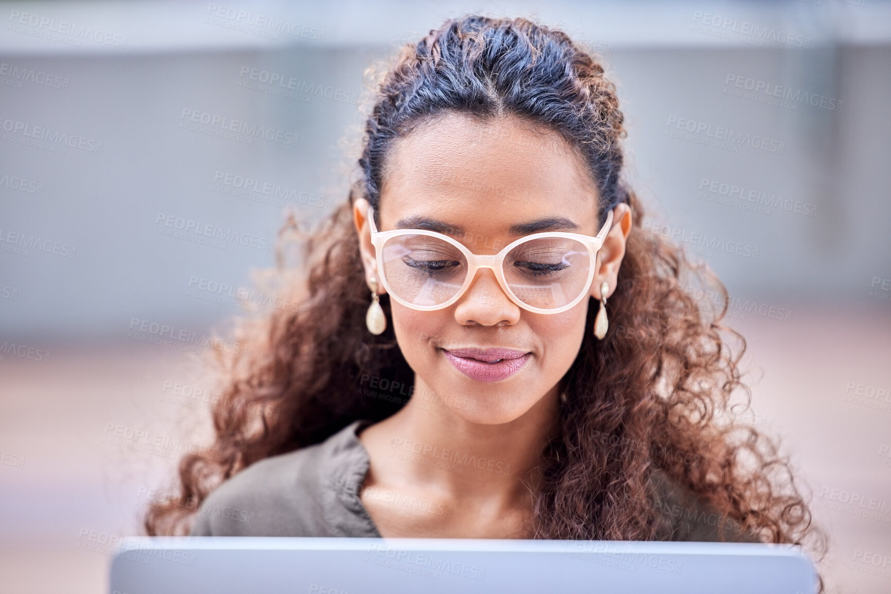 Buy stock photo Shot of a young businesswoman using a laptop at work