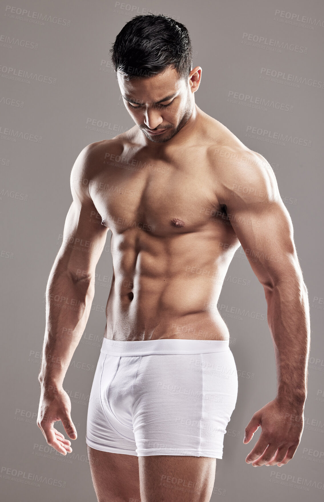 Buy stock photo Man, underwear model and muscle care with strong chest, abs and body with wellness in studio. Bodybuilder, exercise and healthy male person with gray background and muscles from fitness and workout