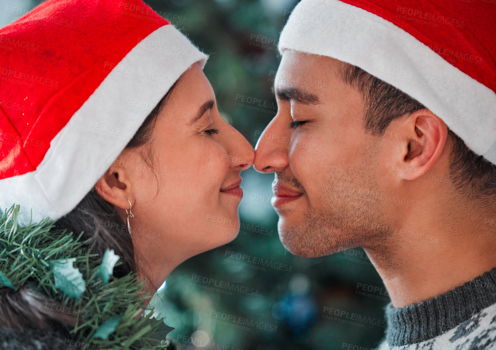 Buy stock photo Love, nose kiss and couple at Christmas in home for festive party or celebration together. Happy, romance and young man and woman with sweet bonding moment for mistletoe at xmas holiday at house.