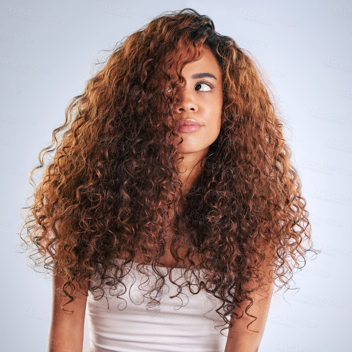 Buy stock photo Beauty, curly or haircare and frustrated woman in studio on gray background with moody expression. Annoyed. hair and salon with African model looking unhappy at aesthetic or cosmetology routine