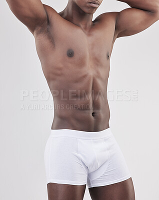 Buy stock photo Black man, healthy and muscle in studio or shirtless with confidence, exercise or strong with stomach. Male person, white background and natural with underwear for fitness, motivation for workout