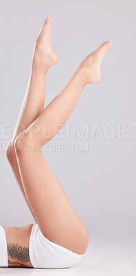 Buy stock photo Cropped shot of an unrecognisable woman lying down and posing in her underwear in the studio