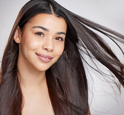 Buy stock photo Studio portrait of an attractive young woman posing against a grey background