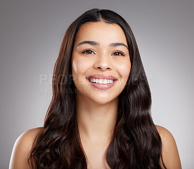 Buy stock photo Studio portrait of an attractive young woman posing against a grey background