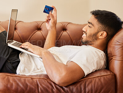 Buy stock photo Man on sofa with laptop, credit card and ecommerce with online shopping payment and fintech. Commercial, sale and shop website with male customer, smile with connectivity and internet banking at home
