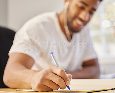 Buy stock photo Hand, writing and man study for college with headphones to listen to music or education podcast in home. Happy, student and learning with notes on university, course or info in notebook for exam