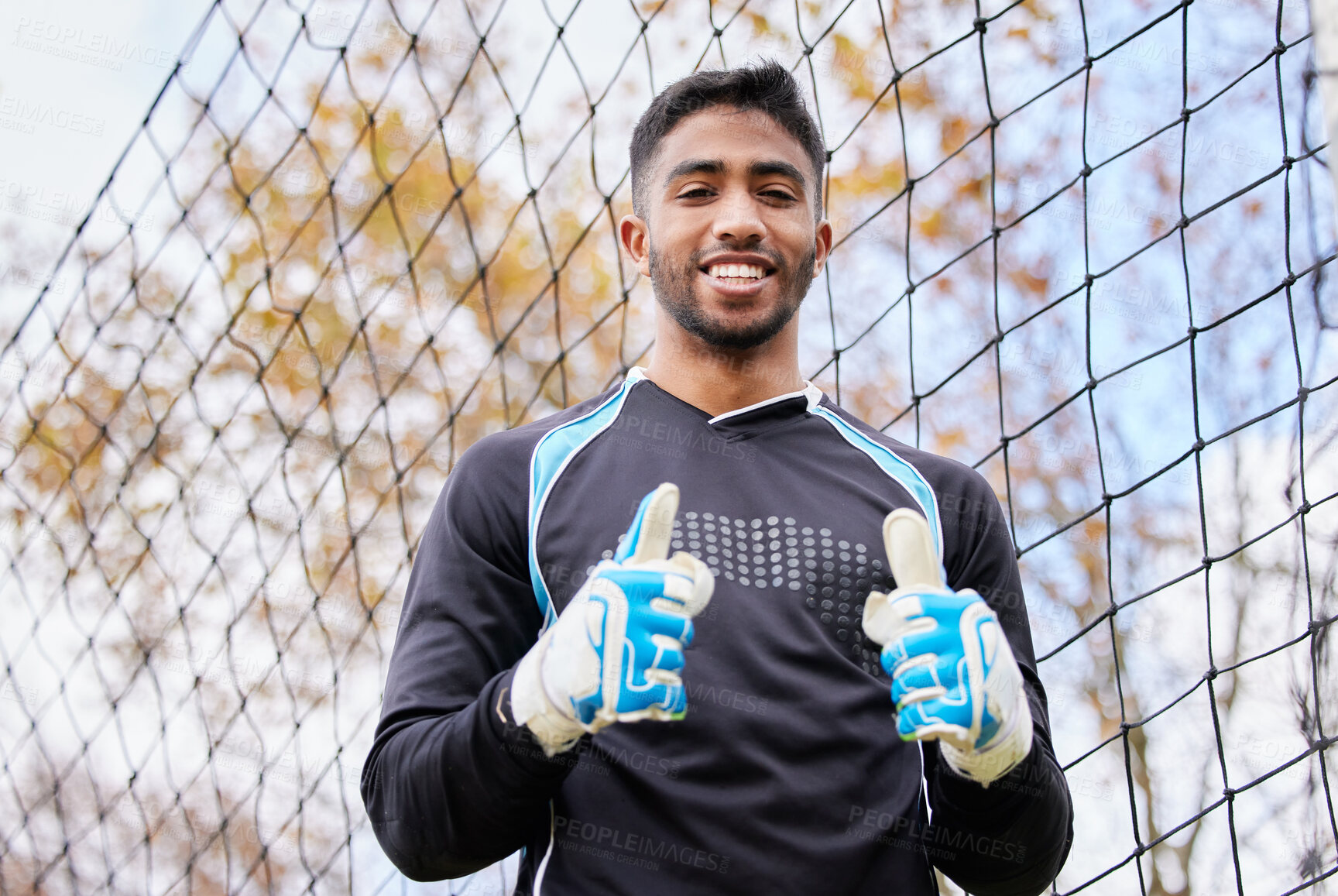 Buy stock photo Thumbs up, goalkeeper and portrait of man on soccer field for success, winner and achievement. Sports, training and competition with male goalie on football pitch for competition, defense and game