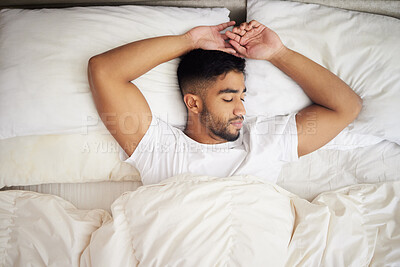 Buy stock photo Sleeping, relax and fatigue, man in bed from above with pillow and duvet in morning, peace and calm in house. Health, wellness and sleep, tired male in bedroom and time to dream in comfort in home.