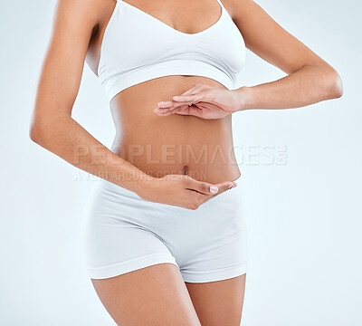 Buy stock photo Health, digestion and hands on stomach for woman in studio, nutrition and gut support on white background. Wellness, fibre and female model, diet and balance fitness body for belly weight loss
