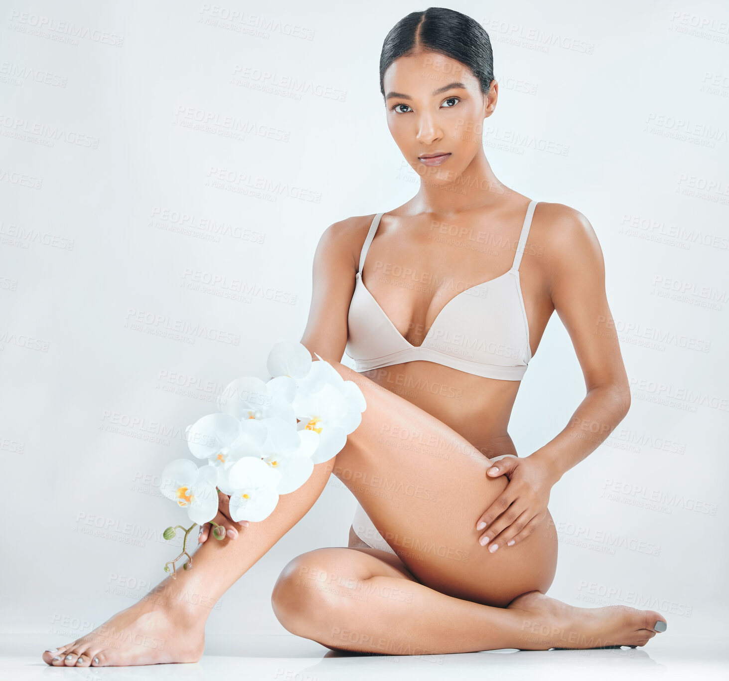 Buy stock photo Portrait, woman and legs on studio background with orchid for cosmetics, cellulite and natural epilation. Laser hair removal, tanning and treatment for skin care, lingerie and body with flowers