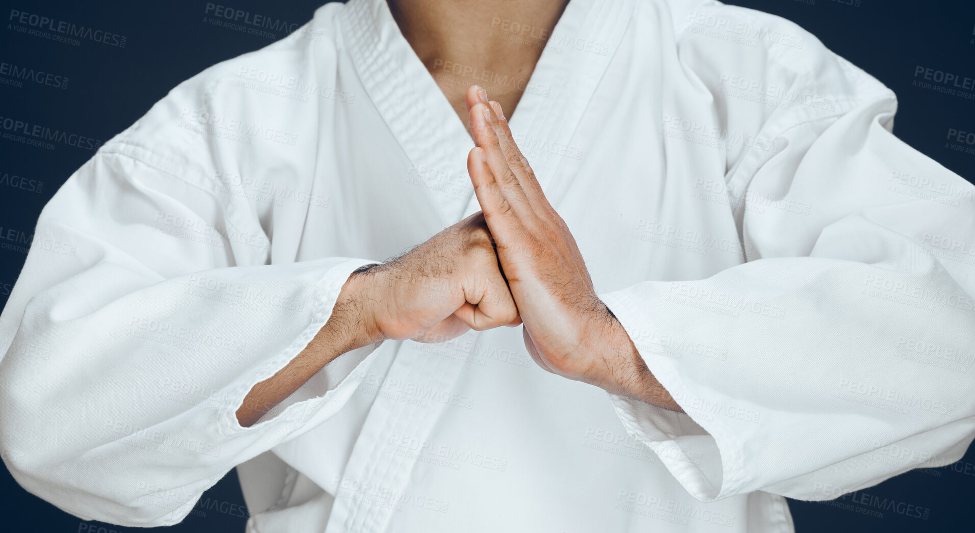 Buy stock photo Man, hands and karate form in studio, fighter and ready for training or practice on dark background. Male person, athlete and warrior in dojo for martial arts, respect gesture and welcome to sports