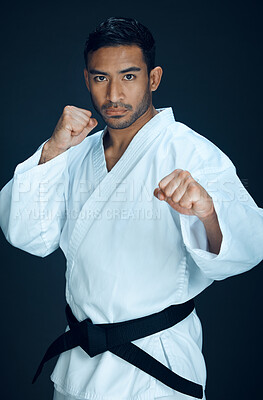 Buy stock photo Karate, master and martial arts portrait of man in studio, black background or practice fight. Sport, challenge and person with self defence skill, technique or mma contest in action with fist