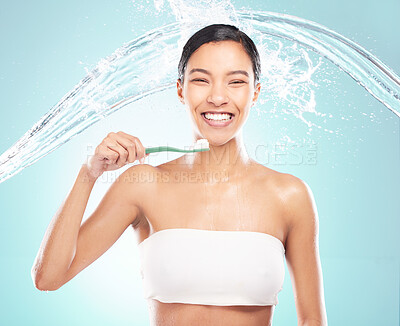Buy stock photo Shot of a young woman brushing her teeth against a studio background