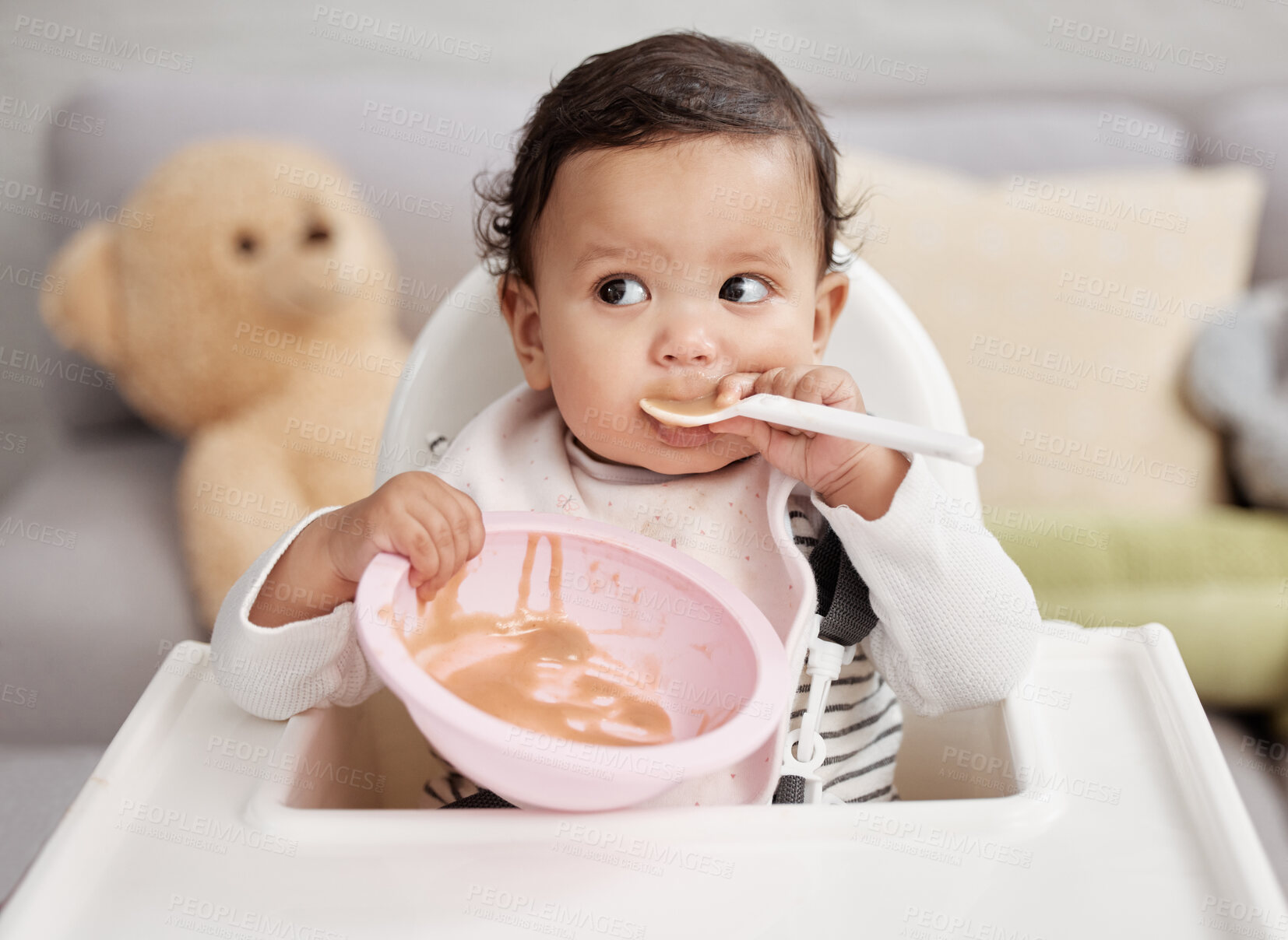 Buy stock photo High chair, food and baby eating in bowl for health, growth development and lunch or breakfast at home. Hungry newborn child or girl with healthy porridge, nutrition and spoon in mouth for learning