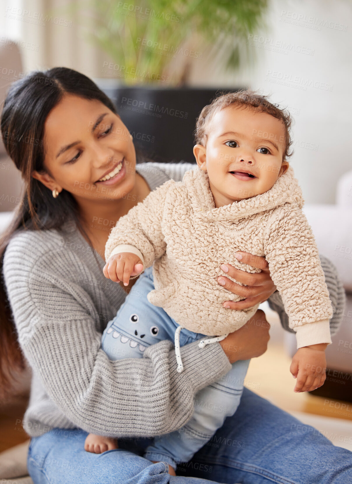 Buy stock photo Love, woman with her baby and in living room of their home happy together. Support or family, happiness and smile with female person holding her toddler for care or affection in lounge at their house