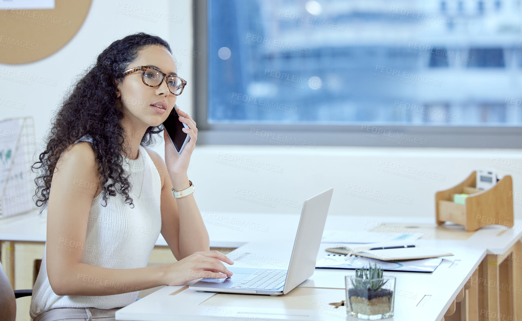 Buy stock photo Shot of a young businesswoman on a call in an office at work