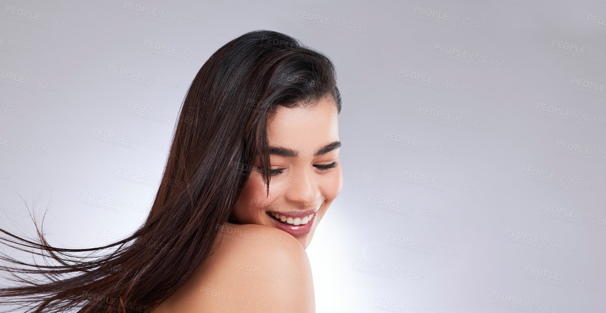 Buy stock photo Studio shot of an attractive young woman posing against a grey background