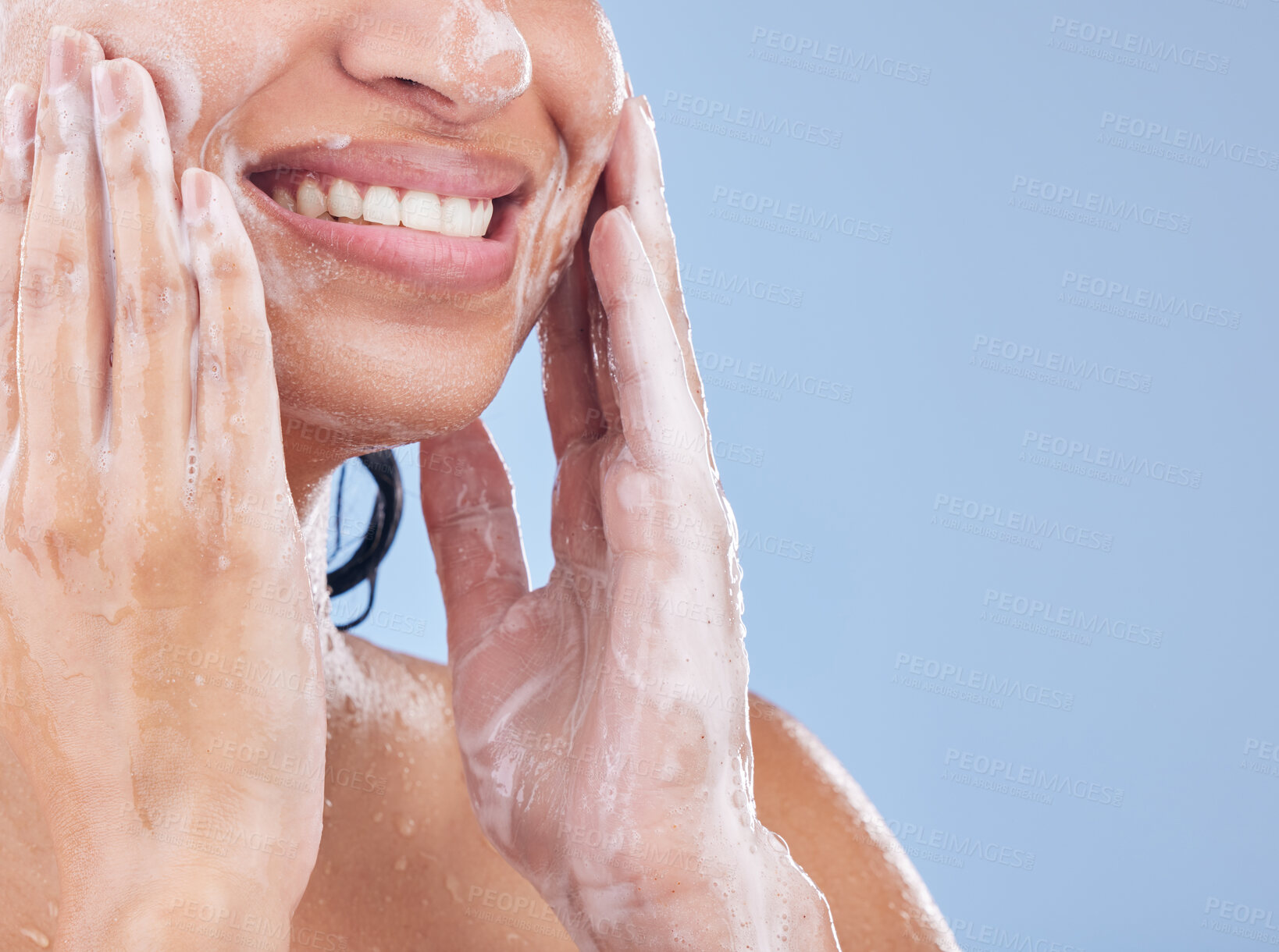 Buy stock photo Cropped shot of a young woman washing her face