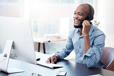 Buy stock photo Cropped shot of a handsome young male call center agent working on his computer in the office