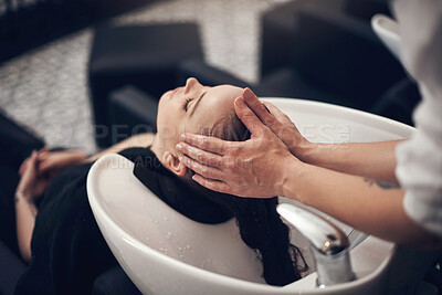 Buy stock photo Shot of a beautiful young woman getting her hair washed at the salon