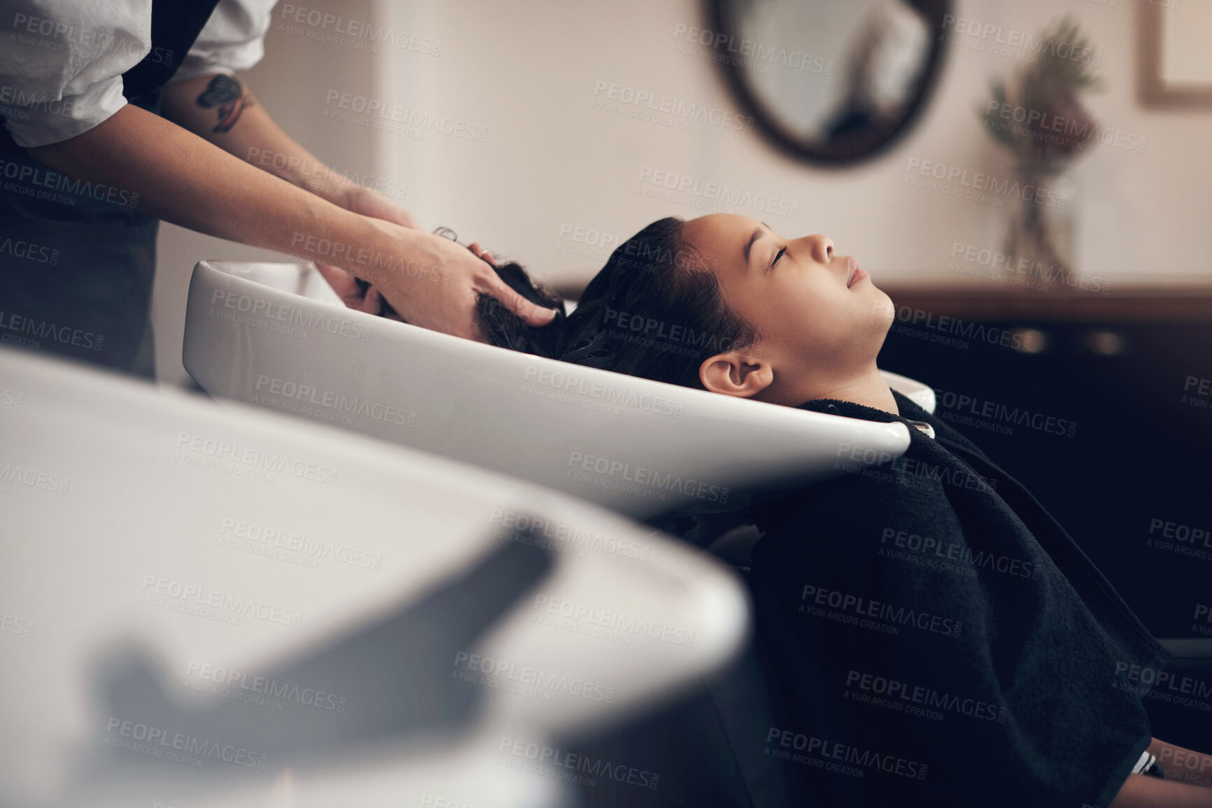 Buy stock photo Washing hair, care or hands of stylist with girl in salon basin for scalp or natural cleaning treatment. Rinse, spa or beauty service for client, child or shampoo cosmetics for health or wellness