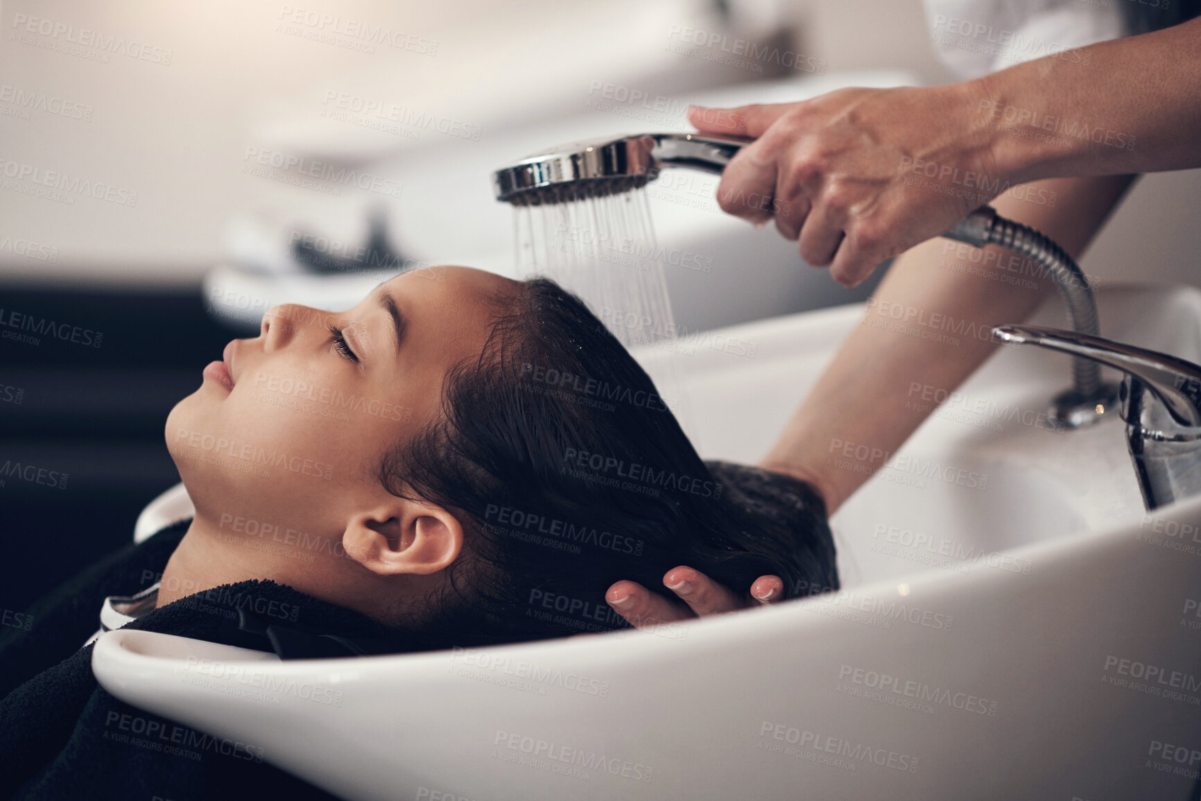 Buy stock photo Wash, girl child and hairdresser with shampoo in salon for hair care, water treatment or conditioner. Above, beauty and client with hands of stylist for cleaning, luxury massage or service by basin