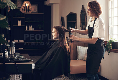 Buy stock photo Hairdresser, woman and client with curling tools for heat treatment, maintenance and haircare of volume style. People, designer and product for blowout, change and healthy shine of salon service