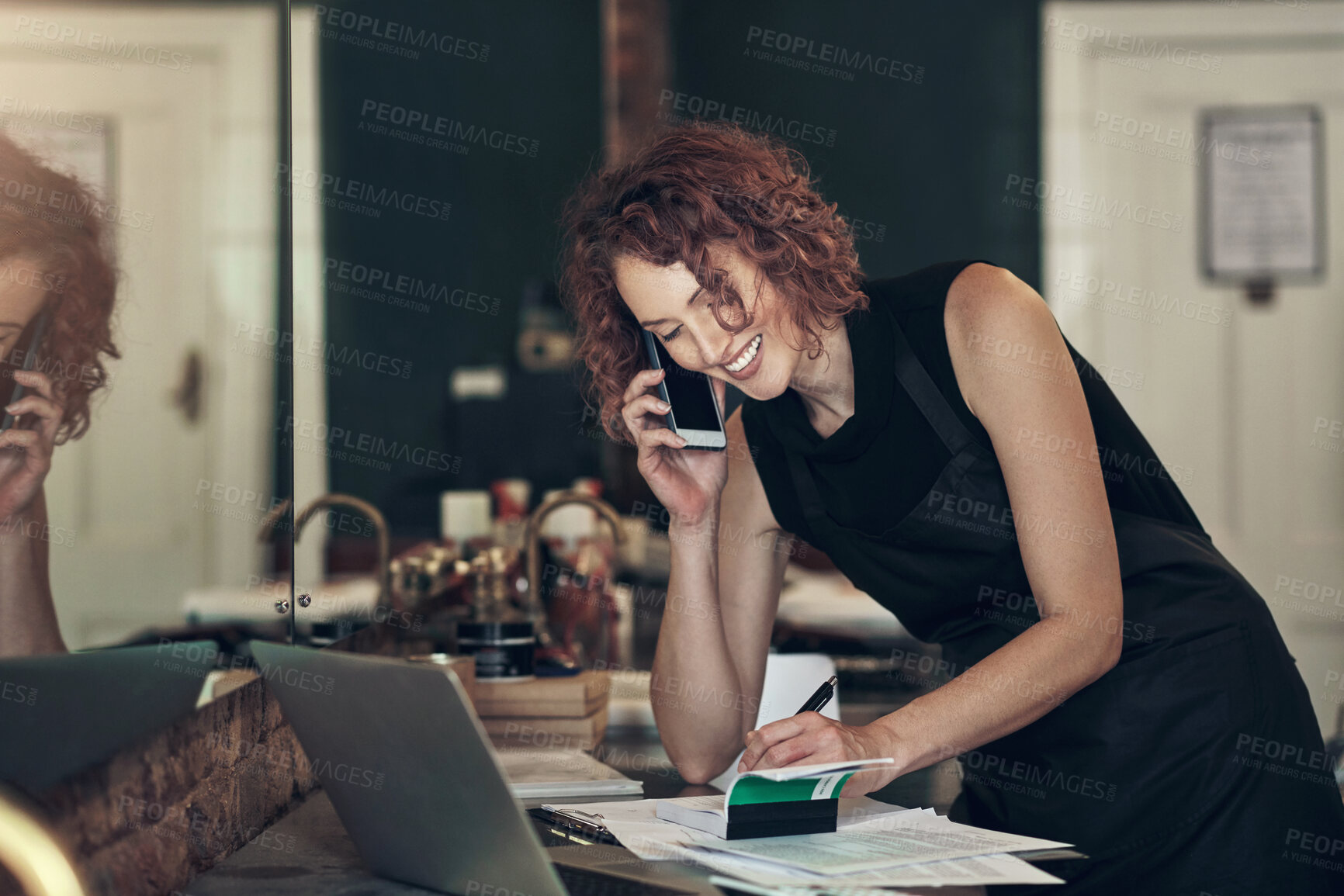 Buy stock photo Hair salon, smile and woman with phone call by book for client, appointment and booking information. Small business, stylist and person with tech by paper for availability, check and customer support