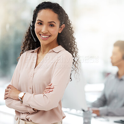 Buy stock photo Portrait of a young call centre agent standing with her arms crossed in an office