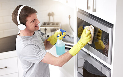 Buy stock photo Man, cleaning and home with music in kitchen, headphone and spray bottle for disinfectant cleaner or germs. Apartment, fabric and rag for health safety, hygiene and bacteria product for maintenance