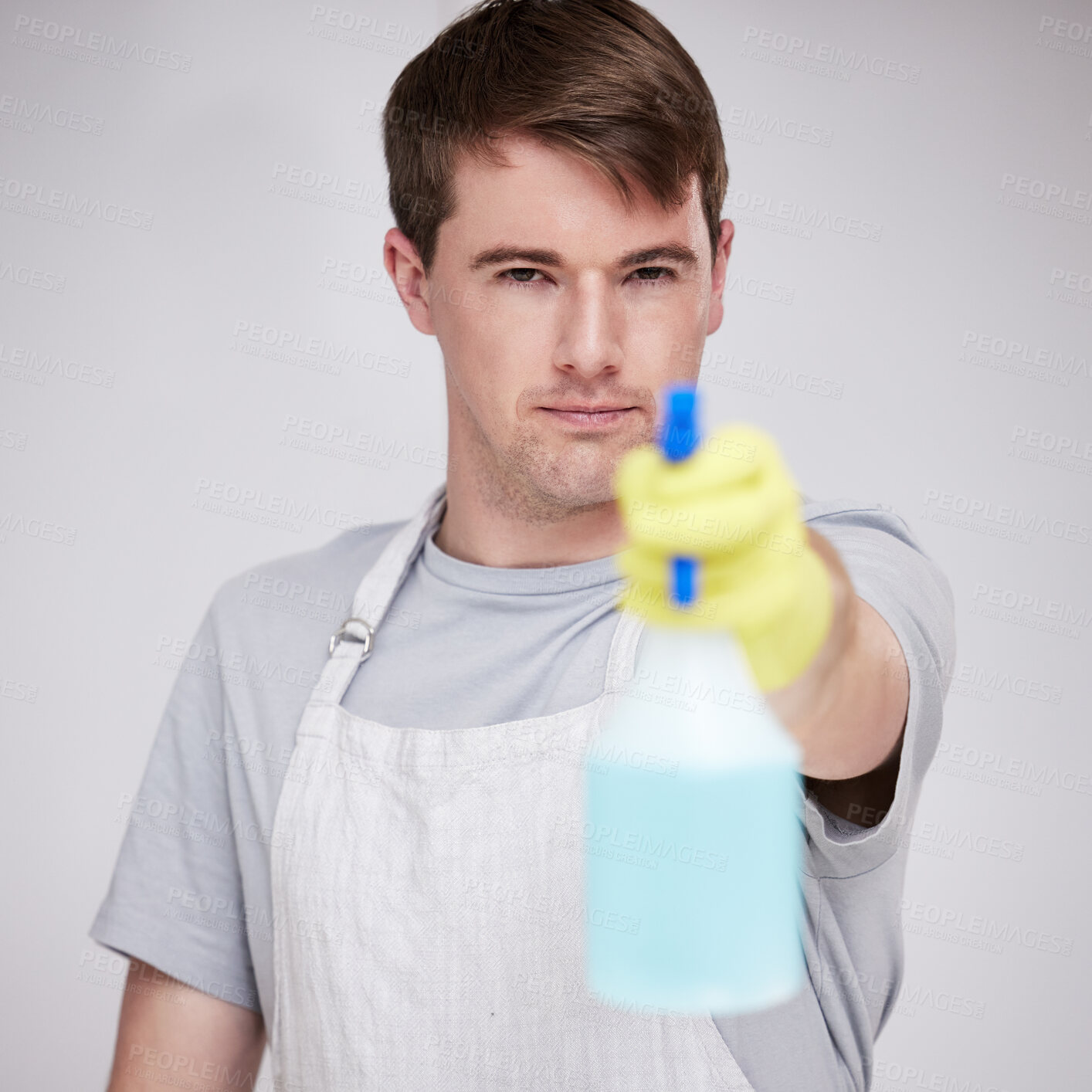 Buy stock photo Man, portrait and studio for cleaning with spray bottle, serious and disinfectant liquid cleaner for germs maintenance. Health, safety and hygiene, glove for bacteria protection on white background