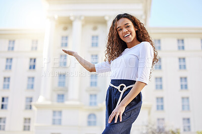 Buy stock photo Shot of a young woman holding out her hand outside