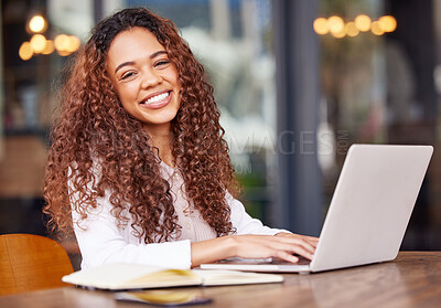 Buy stock photo Shot of a young businesswoman using a laptop while working at a cafe