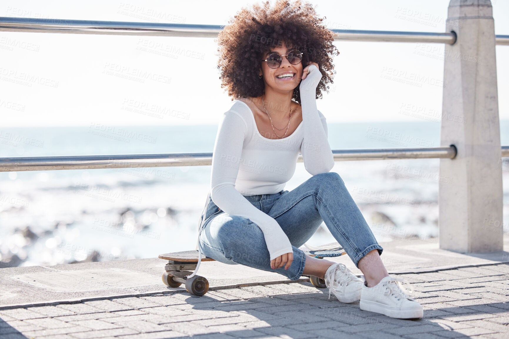 Buy stock photo Happy, ocean and portrait of woman with skateboard for weekend, holiday and vacation in trendy style. Fashion, laugh and person in sunglasses skateboarding for activity, fun and adventure by seaside