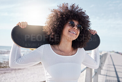 Buy stock photo Happy, summer and black woman by sea with skateboard for weekend, holiday and vacation in style. Fashion, laughing and person skateboarding for activity, freedom and adventure by ocean or seaside