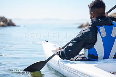 Buy stock photo Rearview shot of a young man kayaking at a lake