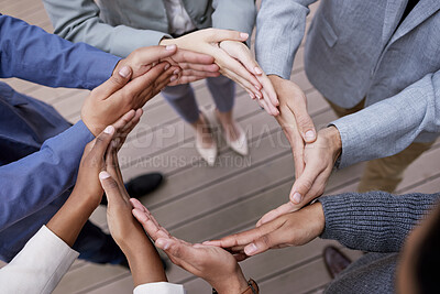 Buy stock photo Shot of a group of unrecognizable businesspeople forming a circle with their hands outside