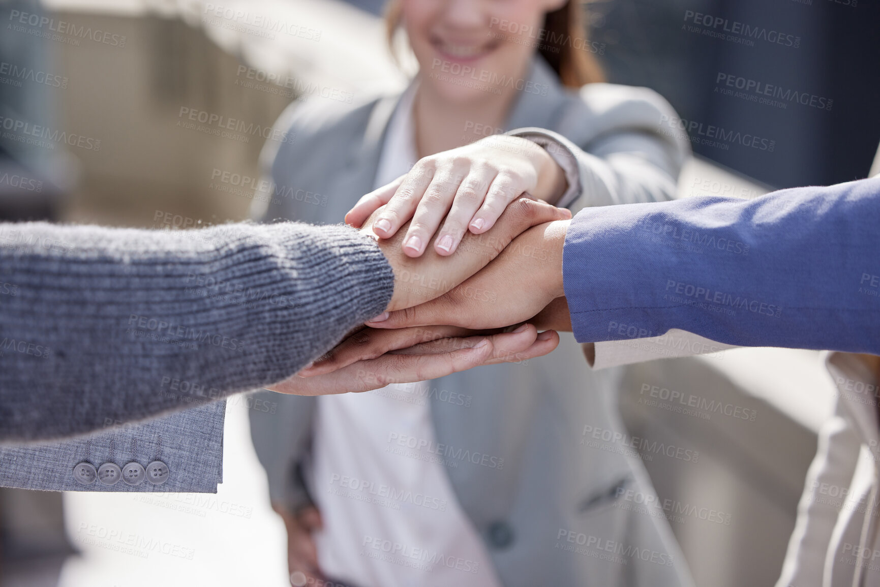 Buy stock photo Shot of a group of unrecognizable businesspeople stacking their hands together outside