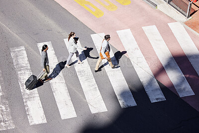 Buy stock photo Shot of a group of young businesspeople crossing the road in the city