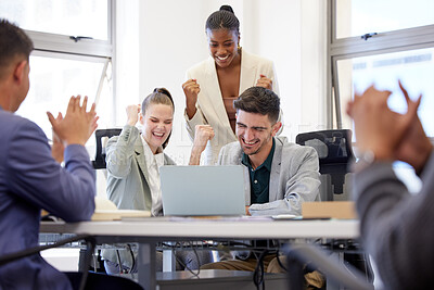 Buy stock photo Shot of a group of businesspeople cheering while using a laptop in an office at work