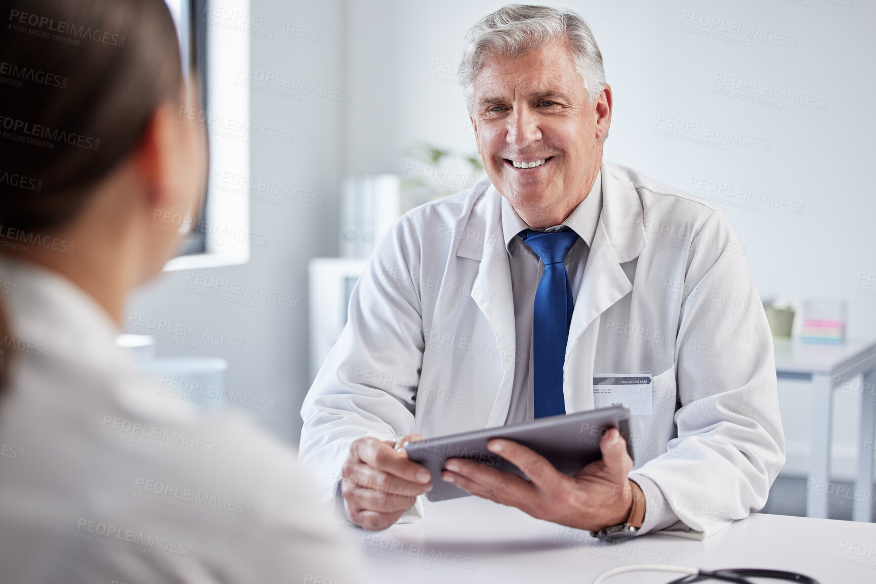 Buy stock photo Mature doctor, man and advice with patient, tablet or happy for giving results, help and good news. Medic, people and digital touchscreen on app for report, diagnosis or healthcare service in clinic
