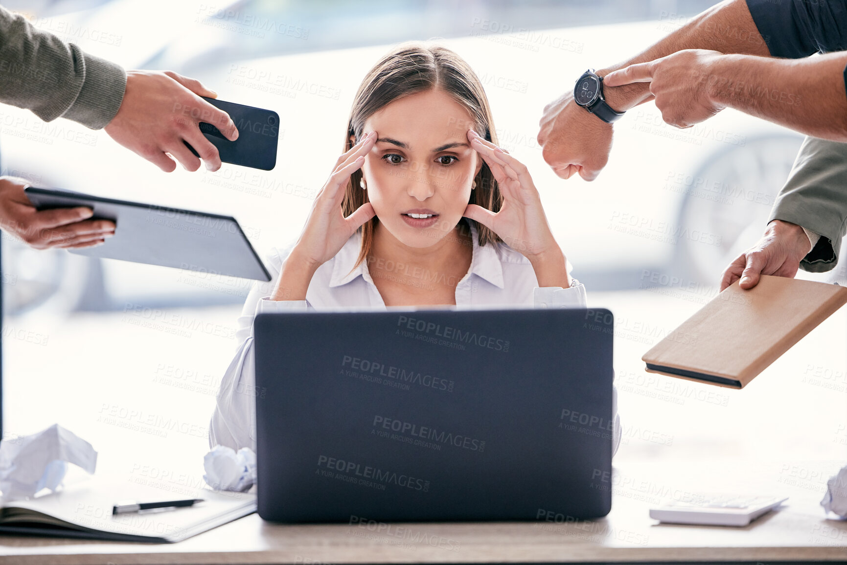 Buy stock photo Shot of an attractive young businesswoman sitting in the office and feeling stressed while her colleagues put pressure on her