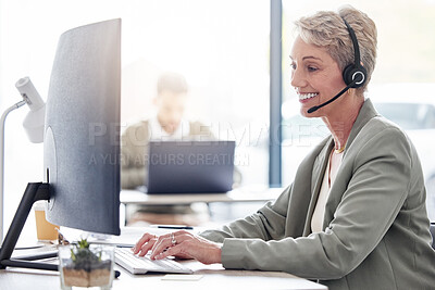 Buy stock photo Cropped shot of an attractive mature female call center agent working in her office