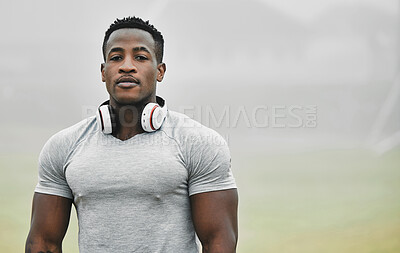 Buy stock photo Cropped portrait of a handsome young male athlete exercising outside