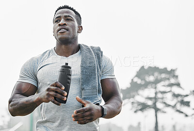 Buy stock photo Cropped shot of a handsome young male athlete out for an early morning run