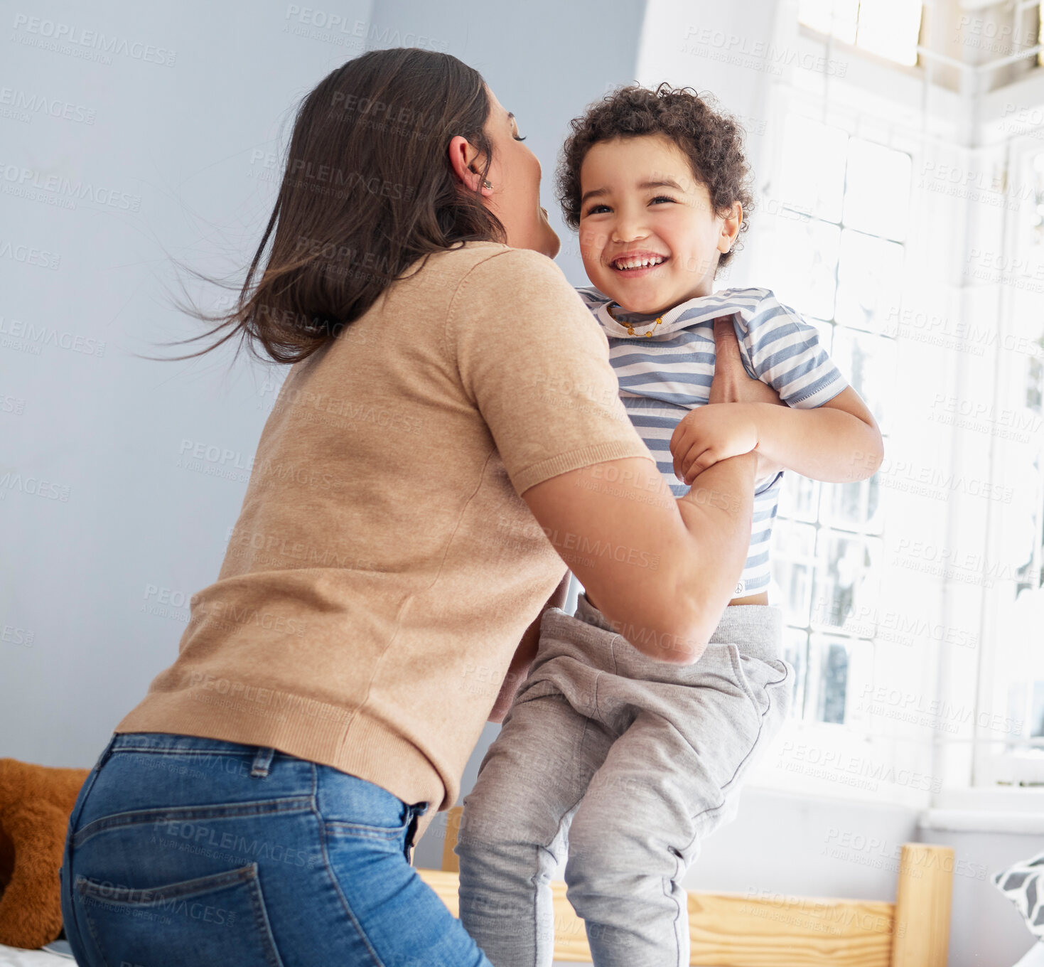 Buy stock photo Mother, boy and jump in bedroom for fun, playful and connection for bonding together in home. Happy people, mom and child with lifting for game, entertainment and energy of single parent with kid 