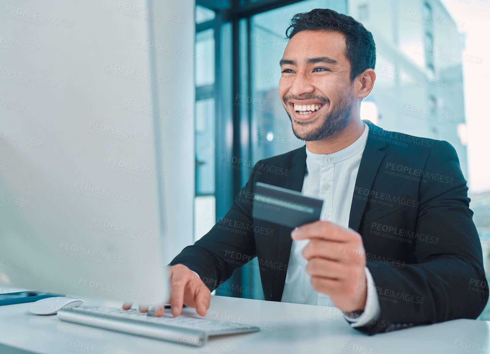 Buy stock photo Shot of a businessman using a computer and credit card at work